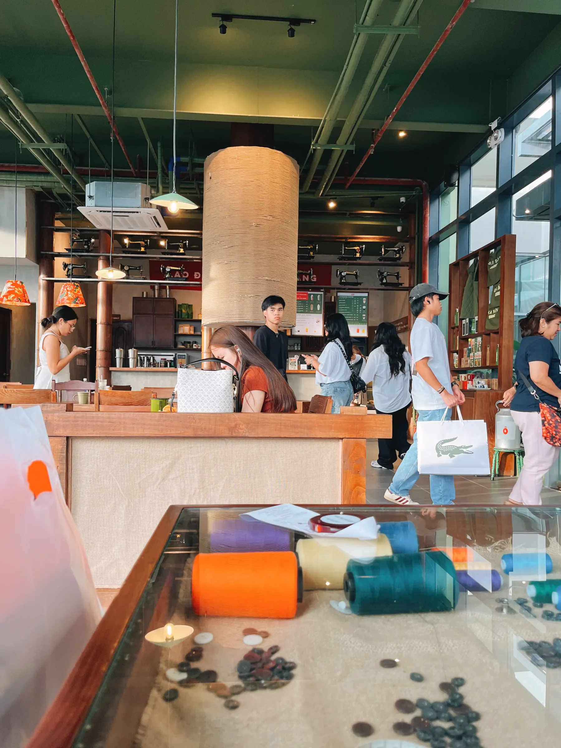 Sewing machines at the back. Sewing kits under the glass.