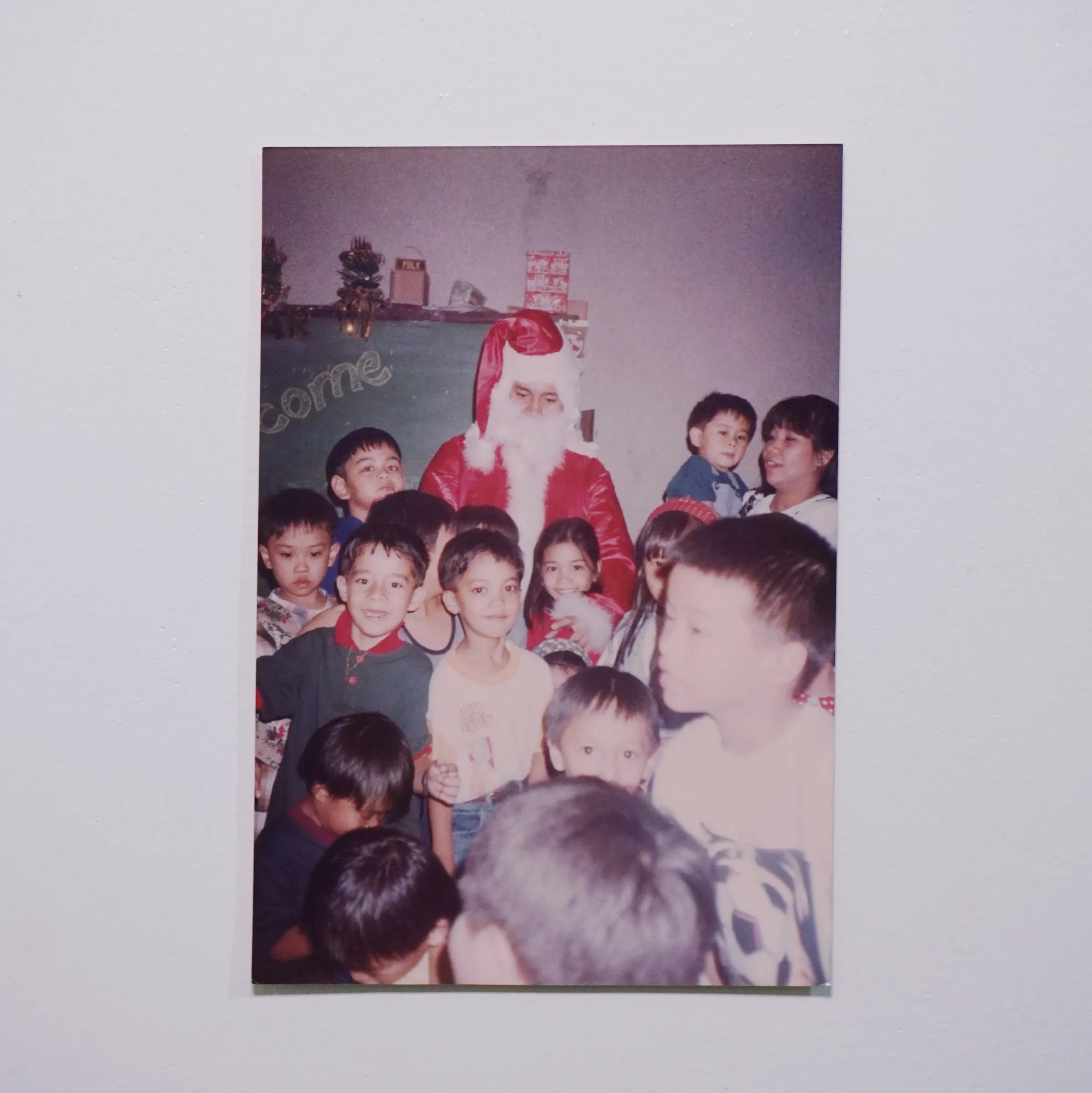 There are many kids looking directly at the camera and smiling. But you still know who the real subject is