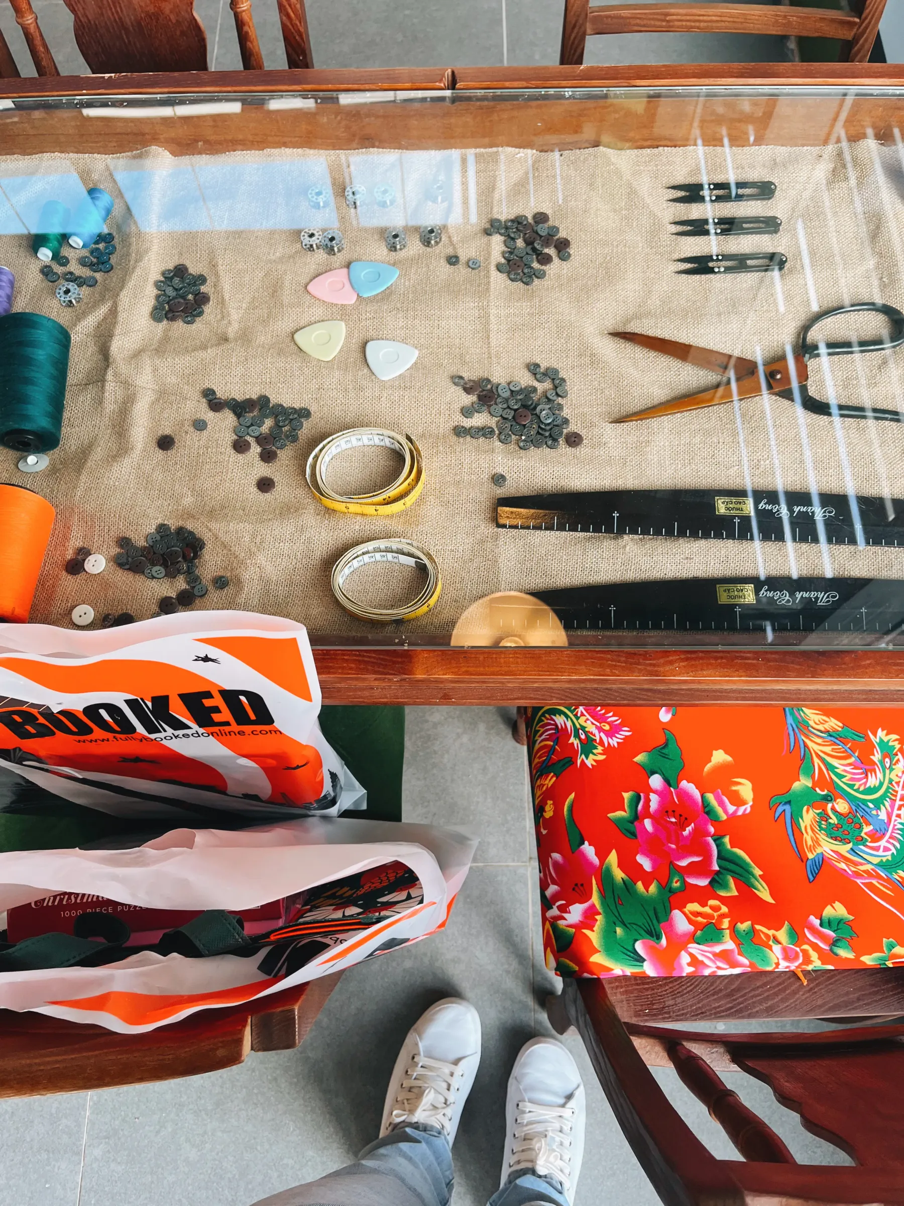 The tabletop featuring sewing tools, a nod to textile factories